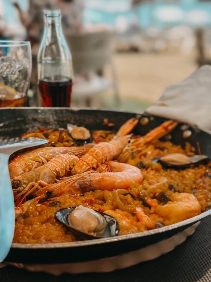 Savor a traditional seafood paella with shrimp, mussels, and rice in Málaga, Spain.